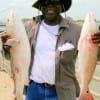 Claude Thomas of Houston wrangled these two nice reds fishing finger mullet.