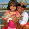 Papacita Robert helps his 2yr old April Aguire of Houston with her redfish catch and release.