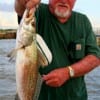 Sid Ingles of Gilchrist holds his breakfast trout caught on finger mullet.
