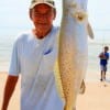 Grandpa Bob Goodman of Gichrist hefts a 6lb speck he caught while surfishing.