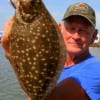 Frank Bunyard of Tarkington Prairrie, TX hefts a nice flounder caught on finger mullet.