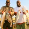 Father and son Vets Rochester Green Sr (Vietnam) and Jr (Iraq) heft their night catch of specks- red- and drum.