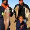 Five yr old Tramaine Jackson, Jr gives thumbs up for dad Tramaine and Donnie O'Quine and their redfish and drum catches.