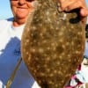 Poochie Walker of League City, TX took this 18 inch flounder on finger mullet.