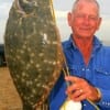 Frank Buyard FINALLY outfished his wife Pat with this 22 inch doormat flounder.