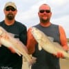 Zeb Roberts and Chuck Krejchi of Salt Lake City, UT heft these two nice slot reds caught on shrimp.