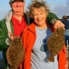 Glenn Hicks and Jim Ray of Beaumont and  Austin TX show their nice flounder caught on mud minnows.