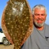 Robert Broussard of Beaumont lifts his 20 inch flounder on a mud minnow.