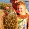 Grandpa and grandson; Steve Crozier and Robbie of Conroe heft a 19 inch flounder caught on finger mullet.