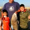 Juan Luna with nephews Luke and Mario of Houston caught and released this bull drum fishing shrimp.