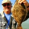 Jim Choate of Gilchrist, TX hefts a nice flounder caught on Gulp.