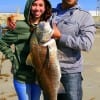 Louis Schaviano and  Alexia Bishop of Sugarland,TX admire their big drum that was caught and  released while fishing shrimp.