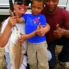 The Wincher Family of  Houston shows off moms 24 inch slot red she caught on shrimp.