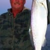 Fred Barker of Kountze,  TX hefts an 8lb trout caught and released by Ed Snyder on a soft  plastic.