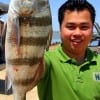 Thomas Tran of  Sugarland, TX shows off his drum he caught on shrimp.