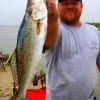 Shane Perrigue of Hampshire TX hefts this nice speck he caught on a finger mullet.