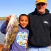 Gramps and grandson, Mark Caski and Dylan Washington of Pearland hefting dylan's drum he caught on live shrimp.