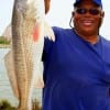 Ronald Bledsole of Houston hefts this 28 inch red caught on a miss nancy shrimp.