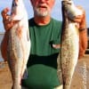 James Tilton of Dayton,TX hefts his two nice trout caught on plastic.