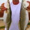 Point Blanc, TX angler Mike Therrell hefts 2 of his many trout he caught night-fishing with plastics.