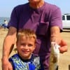 Grandpa and grandson having a great time catching fish at Rollover Pass.