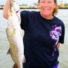 Michelle Frazer of New Caney TX hefts these nice trout caught on soft plastic.