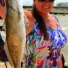 Susan English of Zavalla, TX hefts this nice 4 lb speck caught on a saltwater assasin.
