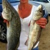Sharon Barker of Kountze, TX hefts 2 of her many trout she caught while night fishing with miss nancys live shrimp.