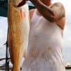 Dallas angler Mark Zapata hefts this36inch tagger bull red he caught on crab.