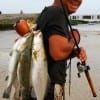 Crystal Beach angler Blake Rising wadefished the surf with an M-54 Mirror lure for this fine stringer of specks