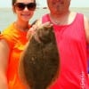 Father and Daughter-Sam Millsaps hefts Shelbie with her nice flounder she caught on a finger mullet-
