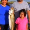 The Garcia Familia-Jessie, Martha and Cindy of Houston heft this 29 inch trout caught on a finger mullet