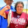 Father and Daughter- Marcelina Gobea helps Kristal with her catch and release speckled trout she caught on live shrimp