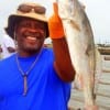Kent Herring of Houston shows off his 21 inch trout he caught on cut croaker