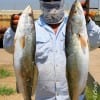 NO, it's not a masked bandito, but Jim Tehrani of Houston with 2 nice specks he caught wade-fishing the surf on Mirro-Lures