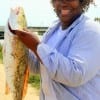 Debra Mills of Houston is excited over her 26 inch slot red she caught on shrimp