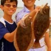 Father and son- Hyungu and Andrew Pack of Katy TX match up their flounder caught on finger mullet
