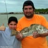 Father and son- Javier and Lorenzo Moreno of Humble heft Lorenzo's drum he caught on live shrimp