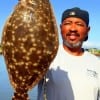 Karl Dever of Houston hefts this large flounder caught on a finger mullet
