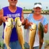 Kimmie and Bobby Richard (Cajun) of Bridge City TX heft 4 of their 5 slot reds they caught on live finger mullet