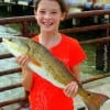 Megan Antley of Montgomery TX hefts this nice 24inch slot red caught on shrimp