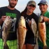 Nick and Martina Germany along with Javier Flores of Montgomery heft their nice drum- bull croaker- and redfish they caught on shrimp