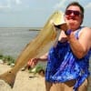 Susan Allmon of Huffman TX caught and released this 35 inch tagger bull red on finger mullet