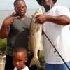 The Herring Family of Missouri City TX show off PaPa's slot red he caught on a finger mullet