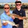 Uncle and Nephew, Crosby TX angler Taylor Hennigan helps Haskell AR angler Gunnar with his redfish and trout he caught on live croaker