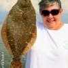 Vicki Harvey of Clear Lake TX hefts this 19 inch flounder caught on a finger mullet