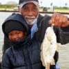 Grandpa and grandson- Louis Eagleton hefts 3yr old Ashton PAPA Johnson's first croaker catch he caught on shrimp