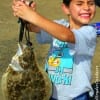 Houston angler 6yr old Jose Rodrigues hefts this nice flounder caught on a finger mullet