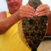 Dennis Boeker of High Island TX grabs onto this 22 inch flounder he just landed while fishing Berkley Gulp