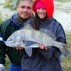Father and daughter, Edgar Villarreal and 11 yr old Eleena of Houston hefts her very first drum she caught on shrimp